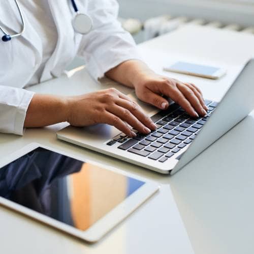 Doctor reviewing records for appraisal and revalidation compliance